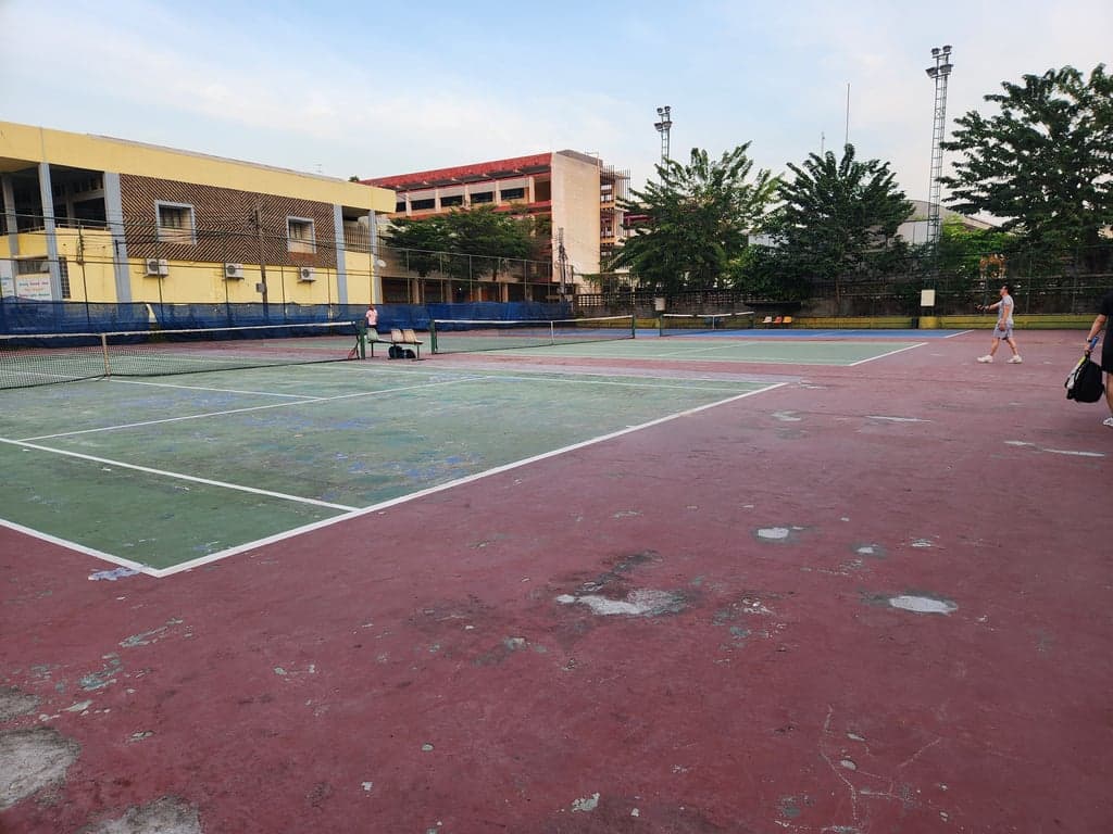 Players on the green hard courts at Rungsang Tennis Courts, Bang Na